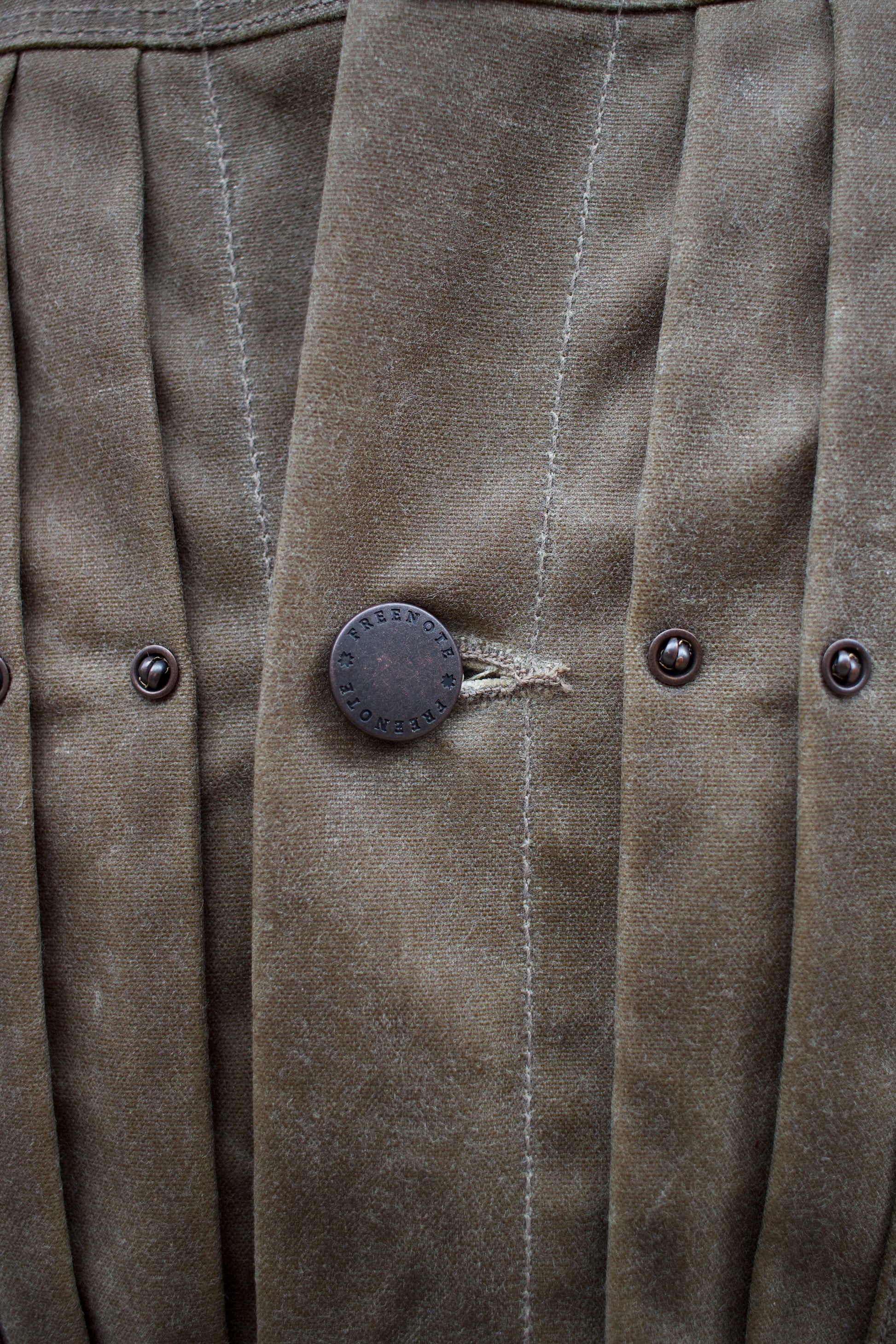 Detail of the hammered buttons on the riders jacket from Freenote Cloth